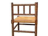 a wooden chair with a woven seat on a white background