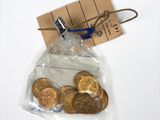 a bag of gold coins with a note attached to it