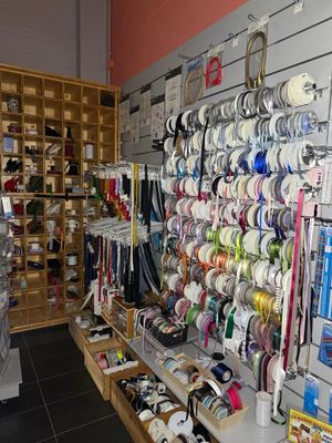 many different types of ribbons on the wall in this store