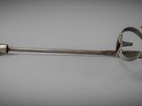 a metal scoop with a wooden handle on a table