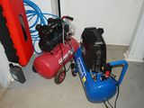 a blue air compressor sitting next to a red air compressor