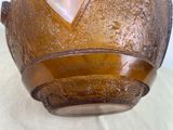 a close up of a brown helmet on a table