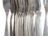 a lot of forks and spoons that are stacked together