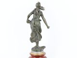 a bronze statue of a woman holding a basket on a wooden base
