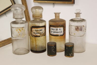 many old bottles of medicine on a table