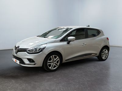 a white car is parked in a room with a black floor