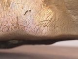 a close up of a bronze statue of a horse