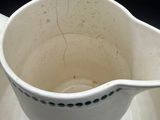 a white bowl and saucer sitting on a saucer