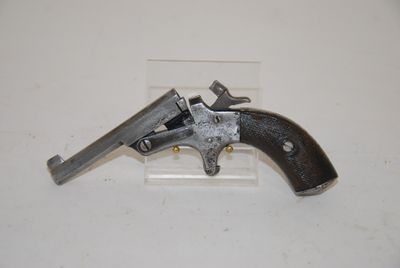 an old gun that is on display on a white surface
