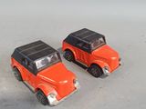 two toy cars that are sitting next to each other