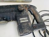 a drill that is sitting on a table next to a box