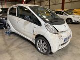 an image of a small white car in a garage