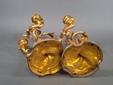 two gold vases sitting next to each other on a table
