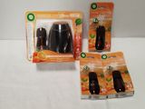 two air freshener bottles and two air freshener bags sitting on a table