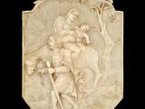 an image of a carved plaque depicting a man and a woman on horseback