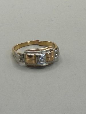 an image of a gold and diamond ring on a table