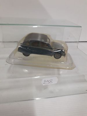 a small toy car in a glass case on a table