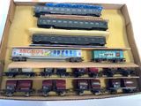 a lot of toy trains in a box on the table