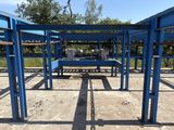 a blue metal structure with benches in the middle of it