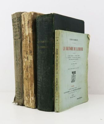 two old books are stacked on top of each other on a table