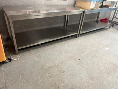a large stainless steel counter in the middle of a room