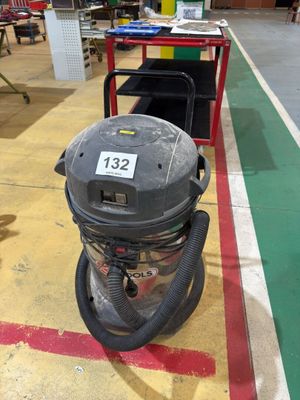 a vacuum that is sitting on the floor in a room
