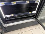 a refrigerated refrigerator in a store with its doors open