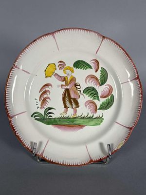 une image représentant une assiette décorative sur laquelle figure un oiseau