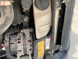 a close up of a car ' s engine and a truck ' s hood