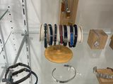 a display of bracelets and watches on display in a glass case
