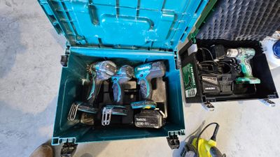 a blue box with tools inside of it on the floor