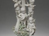 porcelain figurine of a group of cherenshes with flowers in a vase