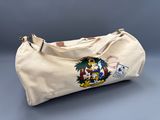 the duffel bag has a cartoon character on it and is sitting on a table