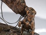 bronze statue of a horse and a dog on a rock