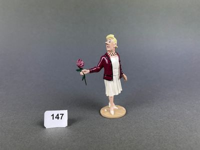 figurine of a woman with a rose in her hand