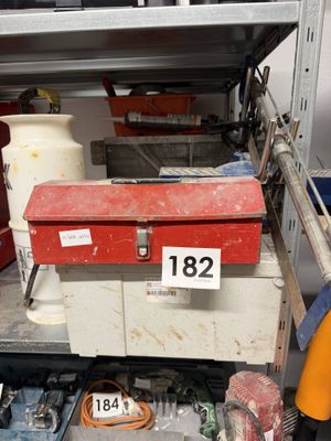 a red tool box sitting on top of a metal shelf