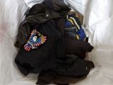 a pile of clothes on a bed in a plastic bag