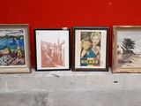 three framed pictures on the wall next to a red wall