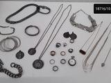 many different types of necklaces and bracelets laid out on a table