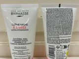 two tubes of body lotion sitting on a counter next to each other