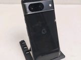 a close up of a cell phone on a stand on a table