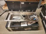 a box with a stove and a sink inside of it