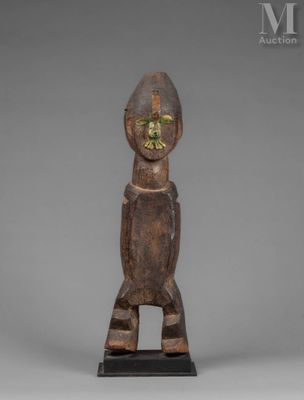 a wooden statue of a man with a green face