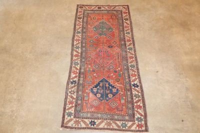 an old rug is laying on the floor in a room