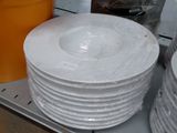 many plates and bowls on a shelf in a store