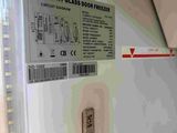 a close up of a glass door freezer with a thermometer