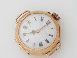 a gold pocket watch with roman numerals on the face