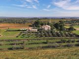 an aerial view of a farm in the middle of a green field