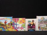 several children ' s books are lined up in a row on a black surface