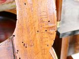 un gros plan d'une chaise en bois percée de trous